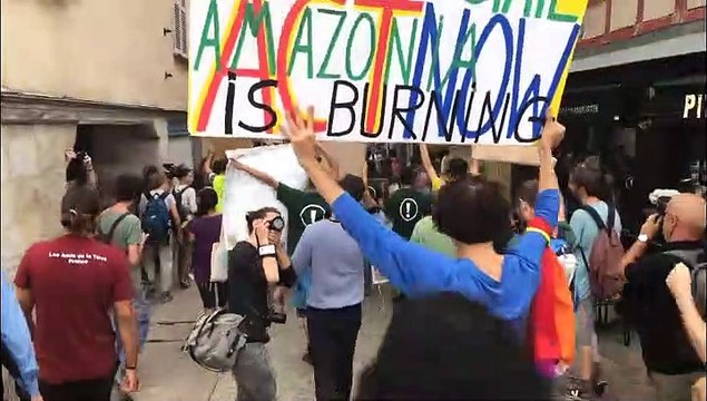 Climate activists rally carrying stolen portraits of Macron near G7