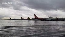 Planes stranded in knee-deep water after Tropical Storm Bailu floods airport