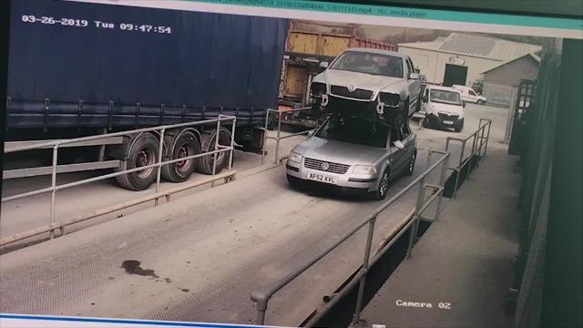 20190829 SWNS This is the hilarious moment a man was caught on camera driving a car - with another car on top