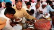 people grabbing food  at a wedding reception in Pakistan  as fast as they can !!!