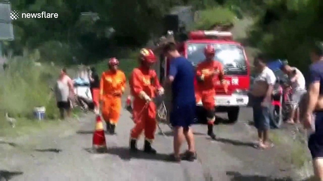 Firefighters in China use crane to rescue elderly man stranded in a river