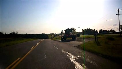 MCH 176 FARMERS DRIVING TRACTOR ON THE BACK ROADS, OF ALBERTA CANADA.