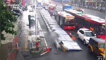 Motorists lift up fence after it was blown over onto several pedestrians in China