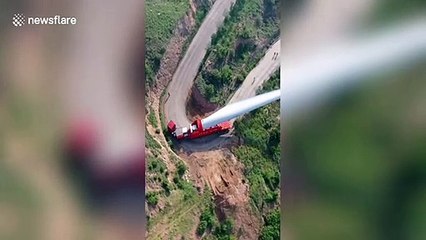 Truck transports 70-metre-long wind turbine blade on winding road in China