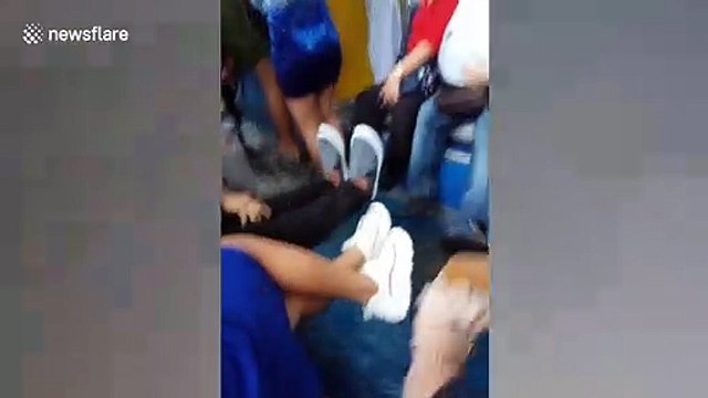 Passengers get their feet soaked when bus drives through flood in the Philippines