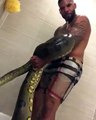 Making money: a Yahoo yahoo boy caught bathing with a deadly Python just to make money online