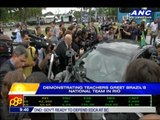 Demonstrating teachers greet Brazil's nat'l team