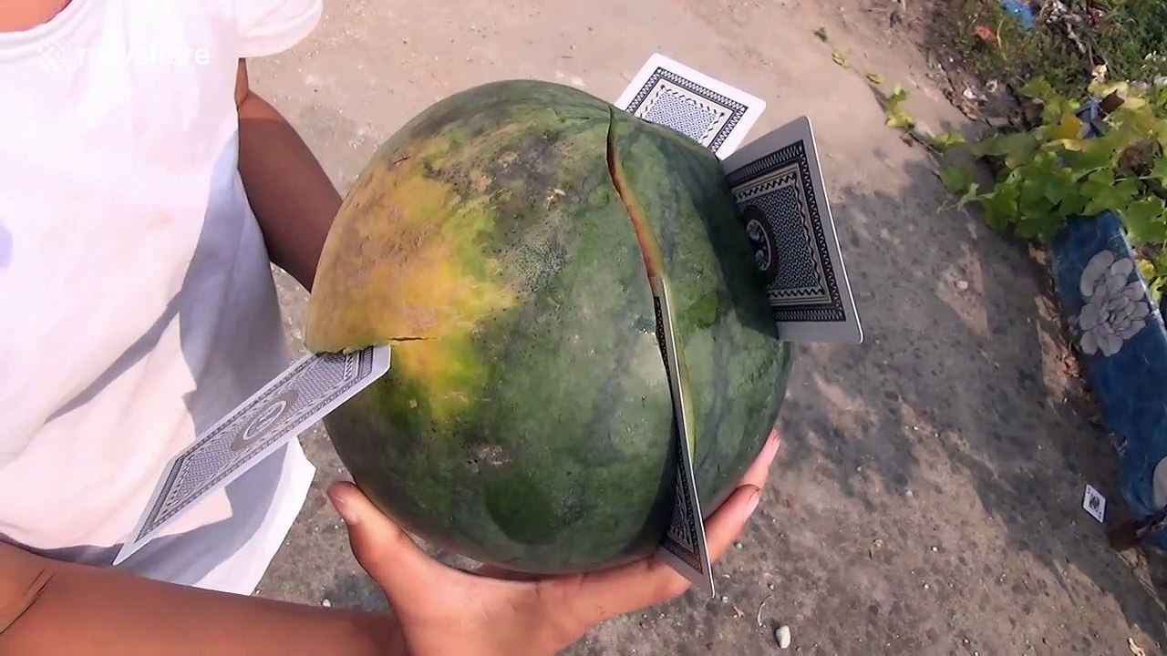 Chinese boy shows off incredible skills by flinging playing cards into fruit