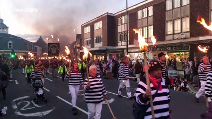 Scores march through English town with torches for bonfire season