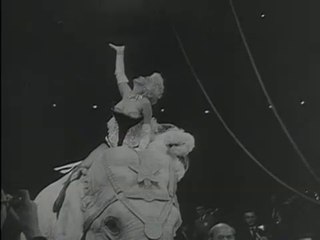 Marilyn Monroe riding a pink elephant (Original News 1955]