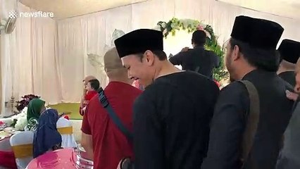 Hilarious moment Malaysian man bumps into his doppelganger at friend's wedding