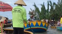 Vietnamese man rapidly spins rowing boat in circular motion while on river