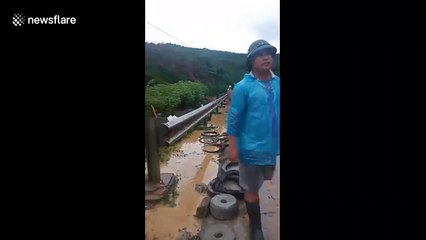 Groom carries bride on his back after landslide blocks road in Vietnam
