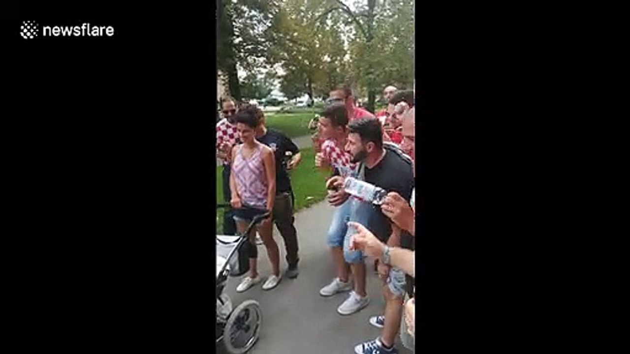 Hilarious scene as Croatian football fans sing random Slovakian baby a lullaby