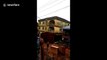 Shocking moment three-storey block collapses in Nigeria after downpour