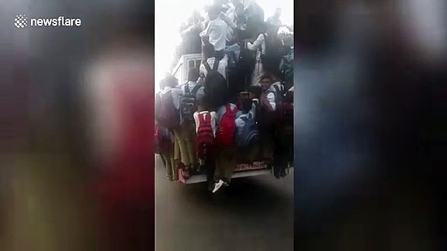 School students cling precariously to moving bus in northern India