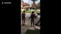 Thai policeman orders schoolboys to do star jumps after catching them riding without helmets