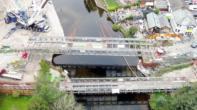 Large construction operation sees bridge lifted by crane over UK river