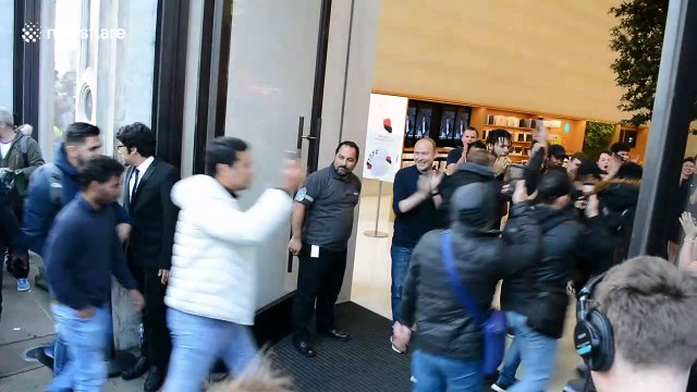Eager fans rush into Apple store in London as new iPhone is released