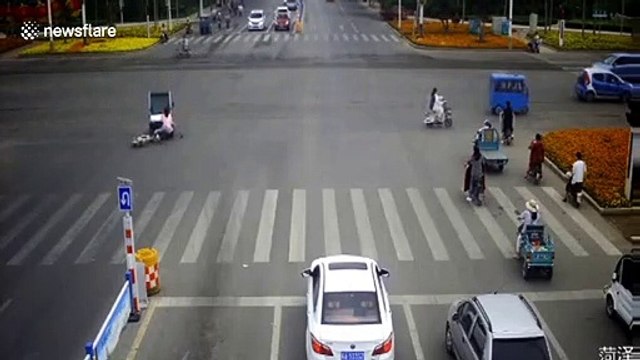 Motorists and passersby lift up car after woman is trapped underneath it on Chinese road
