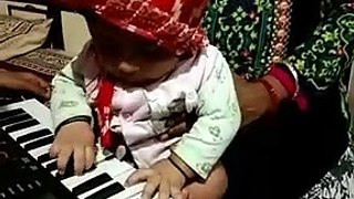 5 months boy playing piano