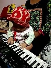5 months boy playing piano