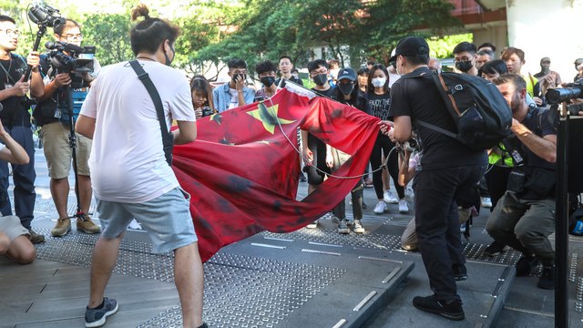 MTR stations shut and police fire tear gas in Sha Tin after Hong Kong protesters start fire and desecrate Chinese flag