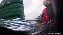 Rainproof cloth smashes car windscreen after falling from truck in China