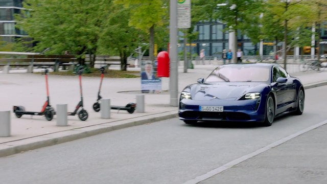 The new Porsche Taycan Turbo in Gentian Blue Metallic Driving in Hamburg & Kiel