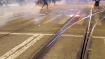 Hong Kong protesters extinguish tear gas fired by police in Wan Chai
