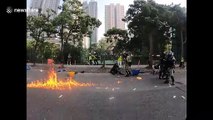 Hong Kong police draw guns on protestors hurling objects during heated clash on China's National Day