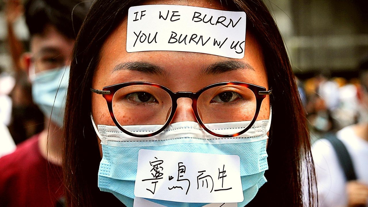 Hong Kong moves to ban face masks as protests continue