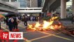 Protesters set fire to China anniversary banner in Hong Kong