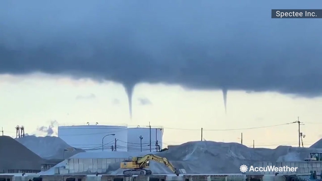 Multiple waterspouts start to spiral down