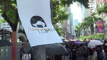 Hong Kong protesters defy mask ban as city grinds to halt