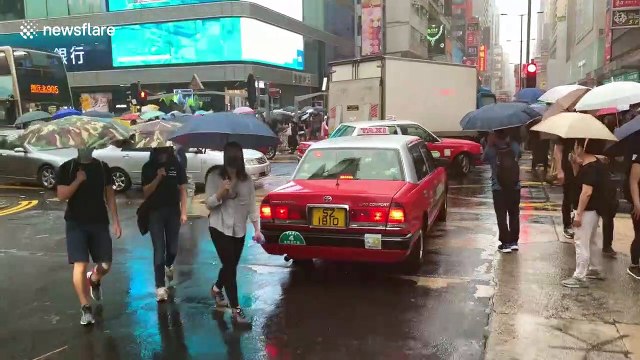 Thousands of protesters take to the streets of Hong Kong to protest against face mask ban