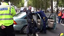 Police remove Extinction Rebellion protesters chained to car outside Ministry of Defence in London
