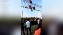 Chinese attraction workers rescue tourists dangling from pedestrian suspension bridge