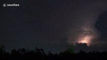 Several aircraft fly towards lightning storm above Pathum Thani, Thailand