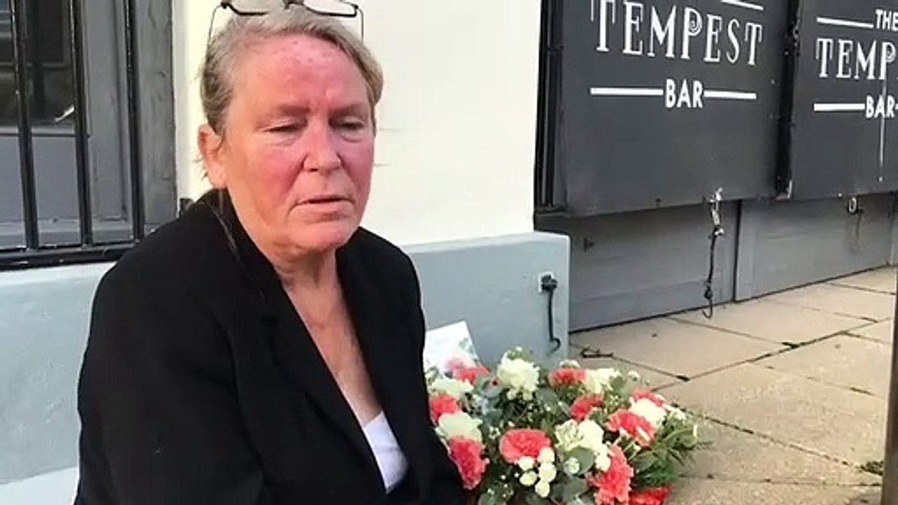 Sharon Henderson lays flowers at the place where her daughter was found dead