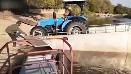 Ils essayent de retirer un tracteur d'un bateau !