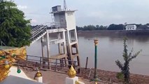 Landslide sparks panic as river bank and buildings collapse into water in Thailand