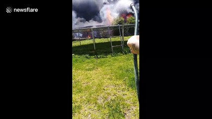 Intense scene as enormous inferno engulfs backyard in Australia while man tries to singlehandedly fight fire
