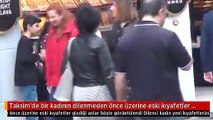 Taksim'de bir kadının dilenmeden önce üzerine eski kıyafetler giydiği anlar böyle görüntülendi