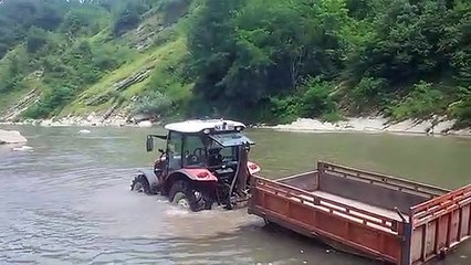 Watch the hard work of the tractor in the river
