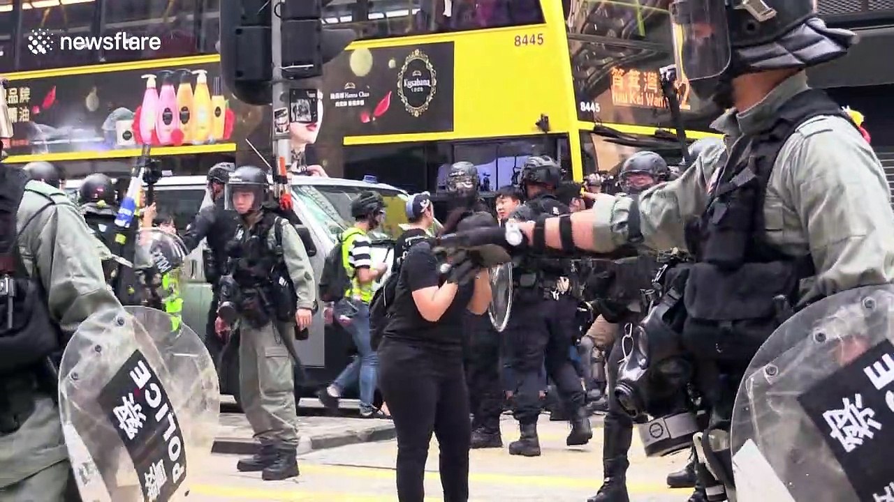 Hong Kong police drag woman across street after pepper-spraying her at point-blank range