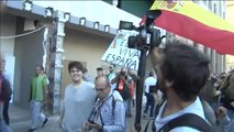 Escoltan a un hombre con la bandera de España durante la manifestación de estudiantes en Barcelona