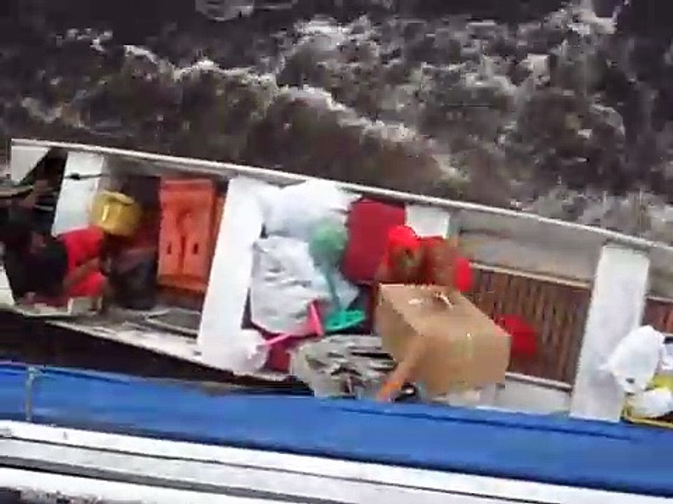 Man Hangs from Boat