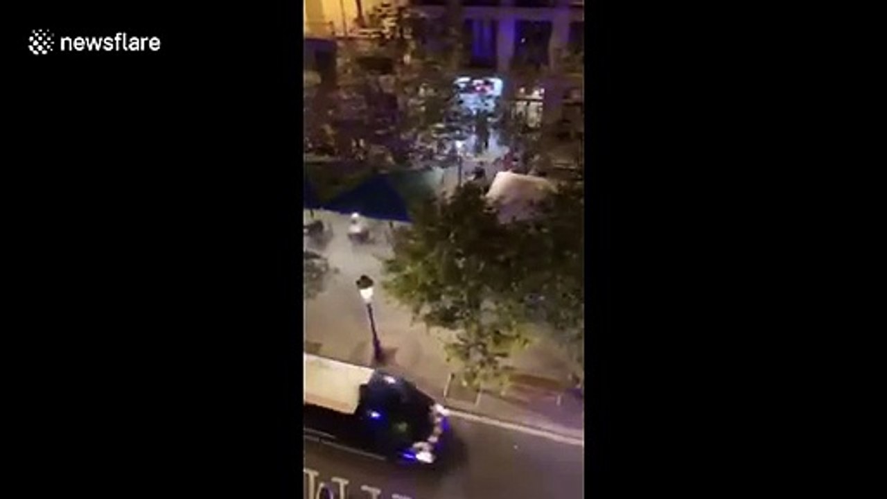 Catalan protestors throw chairs and glasses at riot police truck in running street battles