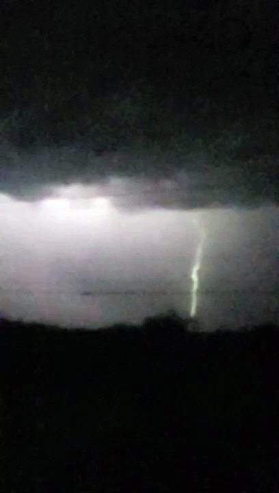 Object Falls from Sky During Slow Motion Lightning Strike